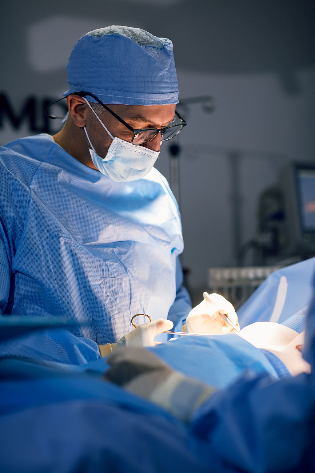 Lymphatic Therapy 1 Dr. Peter Capizzi board certified plastic surgeon in operating room completing a breast augmentation
